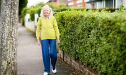 Older resident walking down street in Belfast neighbourhood