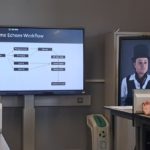 Screens showing images of digital version of historical figure
