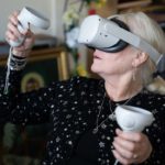 Women using virtual reality headset and hand controls