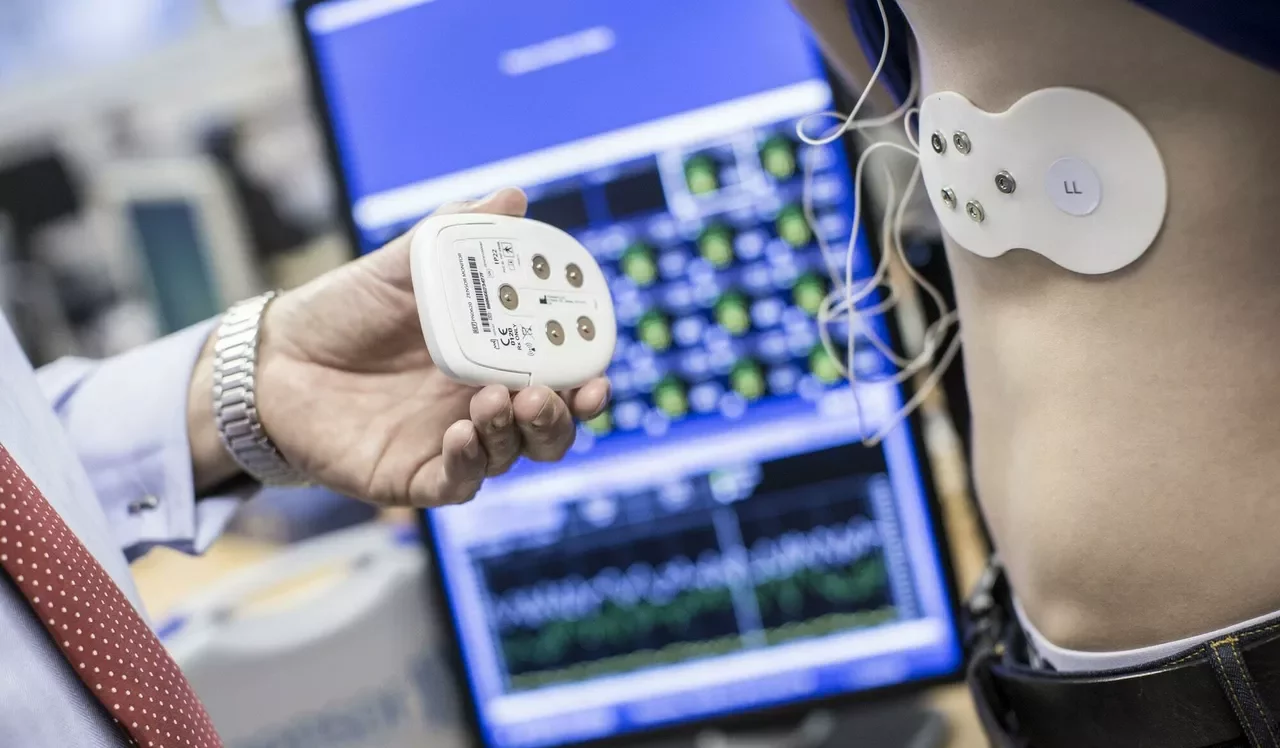 Digital healthcare device being fitted to a man's stomach