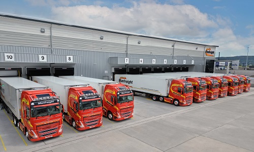 Manfreight lorries lined up outside warehouse