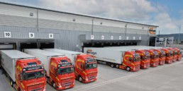 Manfreight lorries lined up outside warehouse