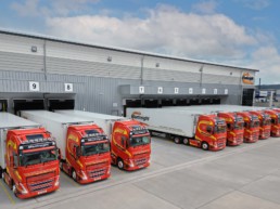 Manfreight lorries lined up outside warehouse